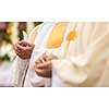 Priest during a wedding ceremony/nuptial mass (shallow DOF; color toned image)