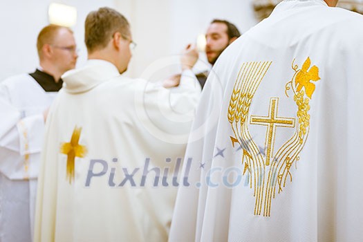 Priest during a wedding ceremony/nuptial mass (shallow DOF; color toned image) Priest during a wedding ceremony/nuptial mass (shallow DOF; color toned image)