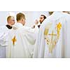 Priest during a wedding ceremony/nuptial mass (shallow DOF; color toned image)