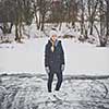 Young woman ice skating outdoors on a pond on a freezing winter day (color toned image; motion blurred image)