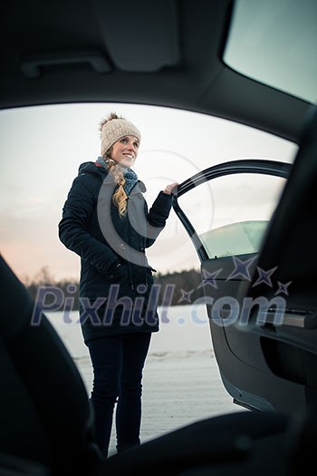 Woman driving a car - female driver at a wheel of a modern car, looking happy, smiling with a relaxed smile (shallow DOF; color toned image) Woman driving a car - female driver at a wheel of a modern car, looking happy, smiling with a relaxed smile (shallow DOF; color toned image)