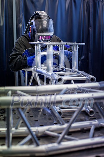 Industrial workers welding metal with many sharp sparks, Welder working a welding metal with protective mask and sparks Industrial workers welding metal with many sharp sparks, Welder working a welding metal with protective mask and sparks