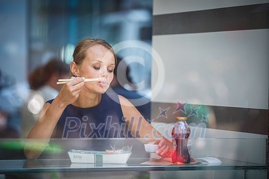 Pretty, young woman eating sushi in a restaurant, having her lunch break, enjoying the food, pausing for a while from her busy corporate/office life (color toned image) Pretty, young woman eating sushi in a restaurant, having her lunch break, enjoying the food, pausing for a while from her busy corporate/office life (color toned image)