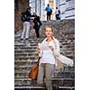 Gorgeous female tourist with a map discovering a foreign city (shallow DOF; color toned image)