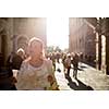 Gorgeous female tourist with a map discovering a foreign city (shallow DOF; color toned image) backlit by warm evening sunshine