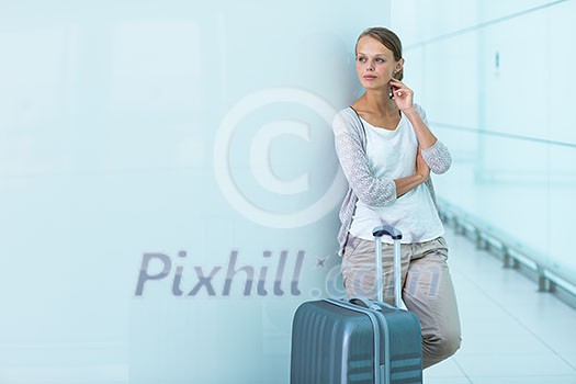 Young female passenger at the airport, waiting for her delayed flight Young female passenger at the airport, waiting for her delayed flight