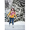 Young woman ice skating outdoors on a pond on a freezing winter day (color toned image; motion blurred image)