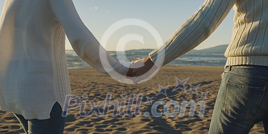Romantic Couple Relaxing On The Beach during autumn day Romantic Couple Relaxing On The Beach during autumn day