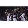 happy american football team celebrating victory with trophy and confetti on the night field