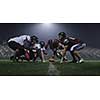 american football players are ready to start on field at night