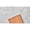 wood cutting board on a gray concrete background. Top view, flat lay