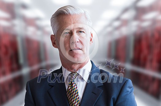 Portrait of senior businessman in big rack server room