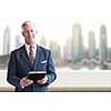 Portrait of senior businessman in front of the big city