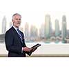 Portrait of senior businessman in front of the big city