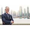 Portrait of senior businessman in front of the big city