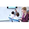 Business Woman Using Digital Tablet in Busy Office