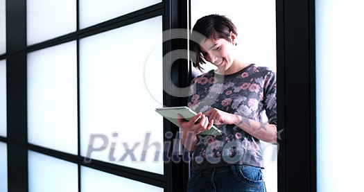 Pretty Businesswoman Using Tablet In front of Office Interior Pretty Businesswoman Using Tablet In front of Office Interior