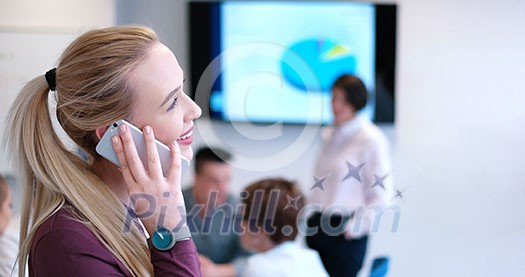 female manager using cell telephone in office interior female manager using cell telephone in office interior