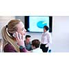 female manager using cell telephone in office interior