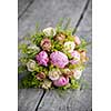 Bouquet of roses on grey wooden planks