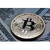 Gold coin Bitcoin on many US dollar banknotes. Investing in crypto currency. Exchange bitcoin cash for a dollar.
