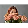 Close-up of a bouquet of beige roses cappuccino.The girl is looking at a bouquet. St. Valentine's Day