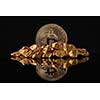 Golden Bitcoin Coin and mound of gold with reflection on a dark glossy background. Concept of financing Bitcoin cryptocurrency in Noble metal