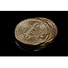 Stacked bitcoin BTC cryptocurrency. BTC golden coins as symbol of electronic virtual money for web banking and international network payment on a black background