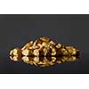 Close up of mound of gold nuggets on a black reflective surface background. Concept of financing and Noble metal