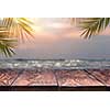 Top of wood table on blurred sea on the sunset with coconut tree background . Empty ready for your product display montage. Concept of beach in summer.