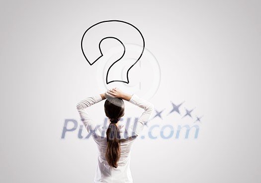 Rear view of businesswoman looking thoughtfully at question mark above head Rear view of businesswoman looking thoughtfully at question mark above head