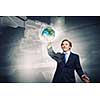 Businessman in suit touching icon of media screen. Elements of this image are furnished by NASA