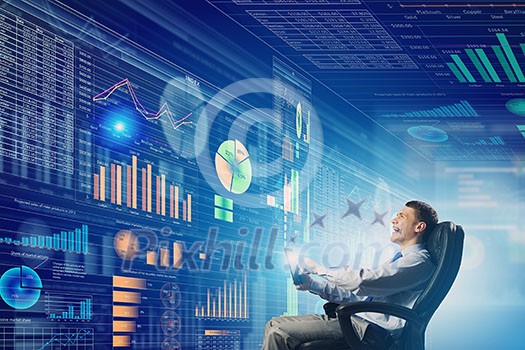 Young businessman with tablet in hands against digital background Young businessman with tablet in hands against digital background