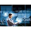 Young businessman with tablet in hands against digital background