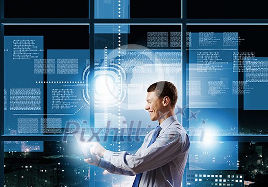 Young businessman with tablet in hands against digital background Young businessman with tablet in hands against digital background