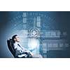 Young businessman with tablet in hands against digital background