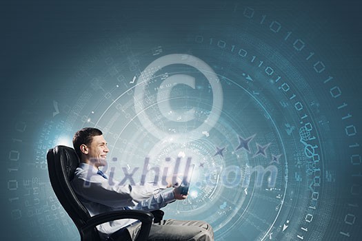 Young businessman with tablet in hands against digital background Young businessman with tablet in hands against digital background