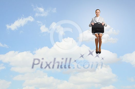 Young pretty businesswoman sitting on cloud high above city Young pretty businesswoman sitting on cloud high above city