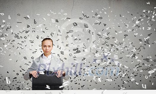 Young pretty businesswoman sitting with briefcase in hands Young pretty businesswoman sitting with briefcase in hands