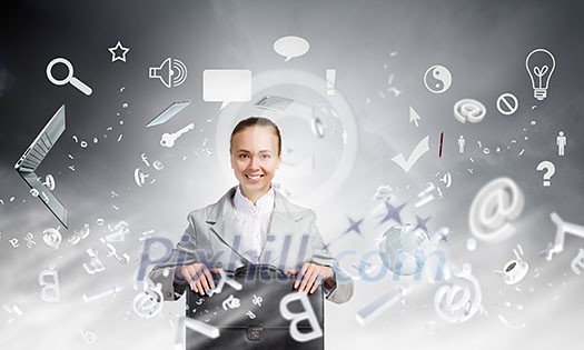 Young pretty businesswoman sitting with briefcase in hands Young pretty businesswoman sitting with briefcase in hands
