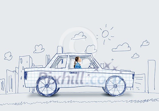 Young girl driving car made of paper Young girl driving car made of paper