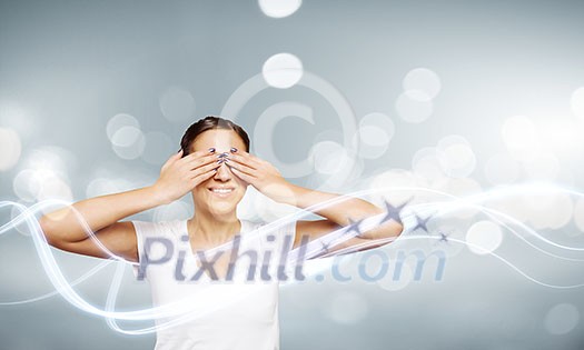 Young woman in white shirt closing eyes with palms Young woman in white shirt closing eyes with palms