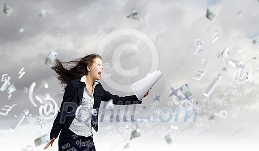 Young determined businesswoman walking against strong wind Young determined businesswoman walking against strong wind