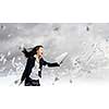 Young determined businesswoman walking against strong wind