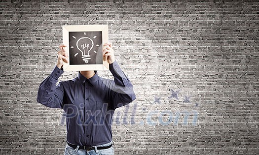 Young woman in shirt with wooden frame in hands Young woman in shirt with wooden frame in hands