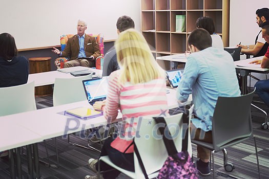 group of students study with professor in modern school classroom group of students study with professor in modern school classroom