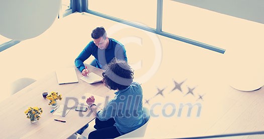 Group of a young business people discussing business plan at modern startup office building Group of a young business people discussing business plan at modern startup office building