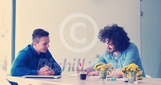 Group of a young business people discussing business plan at modern startup office building Group of a young business people discussing business plan at modern startup office building