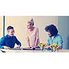 Group of a young business people discussing business plan at modern startup office building