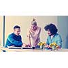 Group of a young business people discussing business plan at modern startup office building